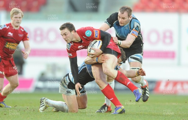 120413 - Scarlets v Glasgow Warriors - RaboDirect PRO12 -George North of Scarlets is tackled by Peter Horne and Al Kellock of Glasgow 