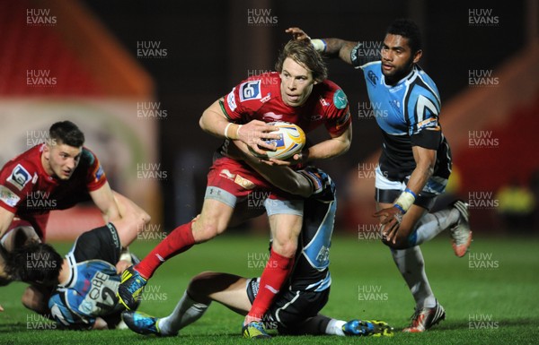 120413 - Scarlets v Glasgow Warriors - RaboDirect PRO12 -Liam Williams of Scarlets is tackled by Duncan Weir of Glasgow 