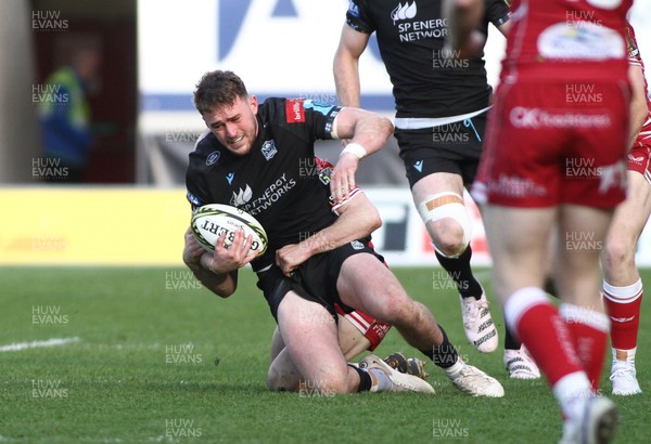 290423 - Scarlets v Glasgow Warriors - EPCR Challenge Cup Semi-Final - Ollie Smith of Glasgow Warriors is tackled by Ioan Nicholas of Scarlets