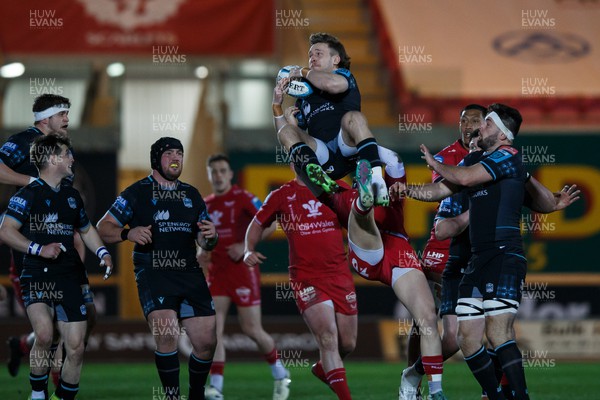 300324 - Scarlets v Glasgow Warriors - United Rugby Championship - Sebastian Cancelliere of Glasgow is taken out in the air by Tom Rogers of Scarlets