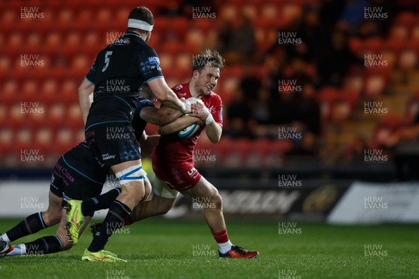 300324 - Scarlets v Glasgow Warriors - United Rugby Championship - Ioan Lloyd of Scarlets is tackled