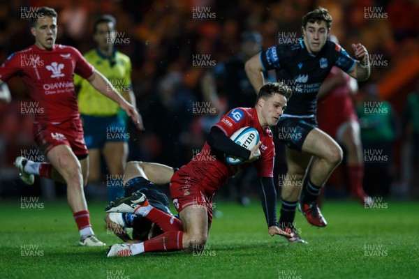300324 - Scarlets v Glasgow Warriors - United Rugby Championship - Tomi Lewis of Scarlets is tackled by Kyle Rowe of Glasgow