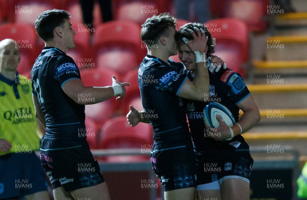 300324 - Scarlets v Glasgow Warriors - United Rugby Championship - Kyle Rowe of Glasgow celebrates with team mates after scoring his second try