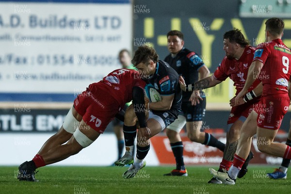 300324 - Scarlets v Glasgow Warriors - United Rugby Championship - Kyle Rowe of Glasgow is tackled by Sam Lousi of Scarlets