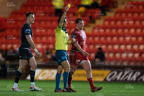 300324 - Scarlets v Glasgow Warriors - United Rugby Championship - Referee Gianluca Gnecchi shows a yellow card to Sam Lousi of Scarlets