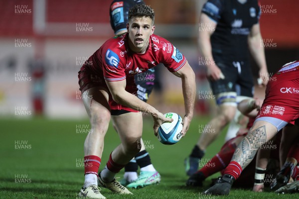 300324 - Scarlets v Glasgow Warriors - United Rugby Championship - Kieran Hardy of Scarlets clears under pressure 
