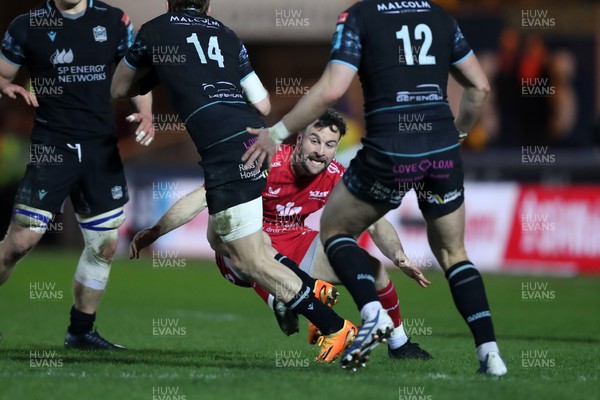 300324 - Scarlets v Glasgow Warriors - United Rugby Championship - Ryan Conbeer of Scarlets tackles Sebastian Cancelliere of Glasgow 