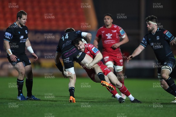 300324 - Scarlets v Glasgow Warriors - United Rugby Championship - Ryan Conbeer of Scarlets tackles Sebastian Cancelliere of Glasgow 