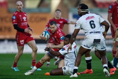 260424 - Scarlets v Hollywoodbets Sharks - United Rugby Championship - Gareth Davies of Scarlets is tackled by Siya Masuku of Sharks