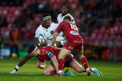 260424 - Scarlets v Hollywoodbets Sharks - United Rugby Championship - Phepsi Buthelezi of Sharks is tackled by Eddie James of Scarlets