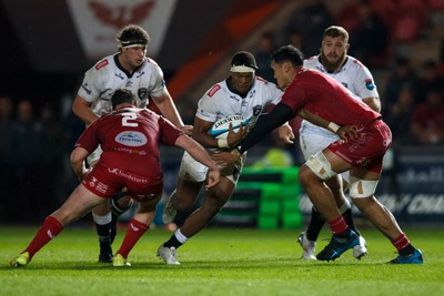 260424 - Scarlets v Hollywoodbets Sharks - United Rugby Championship - Phepsi Buthelezi of Sharks is tackled by Sam Lousi of Scarlets