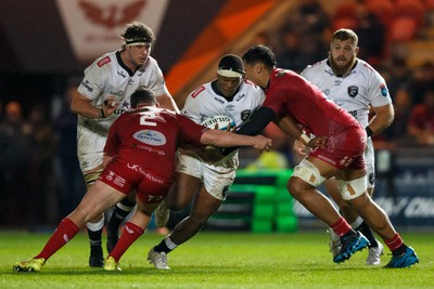 260424 - Scarlets v Hollywoodbets Sharks - United Rugby Championship - Phepsi Buthelezi of Sharks is tackled by Sam Lousi of Scarlets