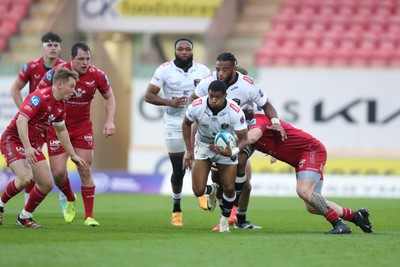 260424 - Scarlets v Hollywoodbets Sharks - United Rugby Championship - Grant Williams of Sharks is tackled by Sam Wainwright of Scarlets 