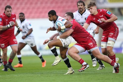 260424 - Scarlets v Hollywoodbets Sharks - United Rugby Championship - Grant Williams of Sharks is tackled by Sam Wainwright of Scarlets 