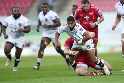 260424 - Scarlets v Hollywoodbets Sharks - United Rugby Championship - Grant Williams of Sharks is tackled by Sam Wainwright of Scarlets 