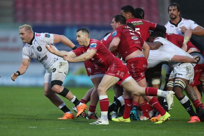 260424 - Scarlets v Hollywoodbets Sharks - United Rugby Championship - Gareth Davies of Scarlets gets the ball away 