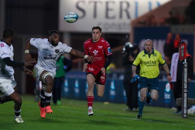 260424 - Scarlets v Hollywoodbets Sharks - United Rugby Championship - Tomi Lewis of Scarlets kicks ahead