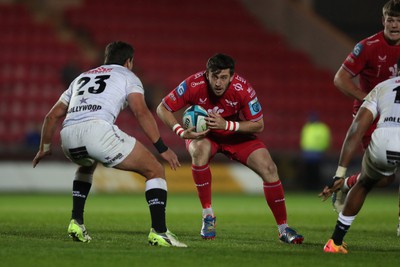 260424 - Scarlets v Hollywoodbets Sharks - United Rugby Championship - Dan Jones of Scarlets charges at Francois Venter of Sharks 