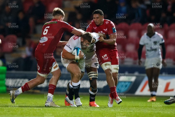 260424 - Scarlets v Hollywoodbets Sharks - United Rugby Championship - Vincent Tshituka of Sharks is tackled by Taine Plumtree and Dan Davis of Scarlets