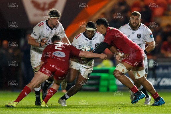 260424 - Scarlets v Hollywoodbets Sharks - United Rugby Championship - Phepsi Buthelezi of Sharks is tackled by Sam Lousi of Scarlets