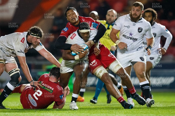 260424 - Scarlets v Hollywoodbets Sharks - United Rugby Championship - Phepsi Buthelezi of Sharks is tackled by Sam Lousi of Scarlets