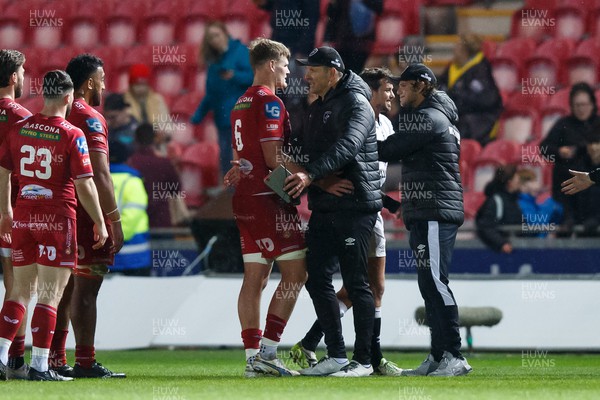 260424 - Scarlets v Hollywoodbets Sharks - United Rugby Championship - Taine Plumtree of Scarlets and Sharks head coach John Plumtree at the end of the match