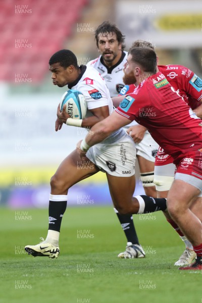 260424 - Scarlets v Hollywoodbets Sharks - United Rugby Championship - Grant Williams of Sharks is tackled by Sam Wainwright of Scarlets 