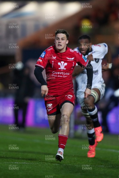 260424 - Scarlets v Hollywoodbets Sharks - United Rugby Championship - Tomi Lewis of Scarlets chases his kick