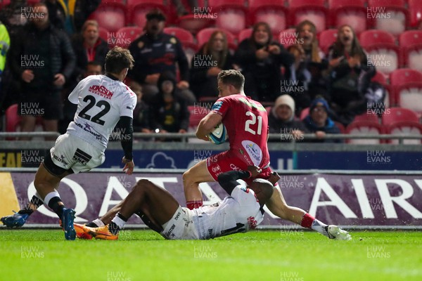 260424 - Scarlets v Hollywoodbets Sharks - United Rugby Championship - Kieran Hardy of Scarlets is stopped short of the line by Makazole Mapimpi of Sharks 