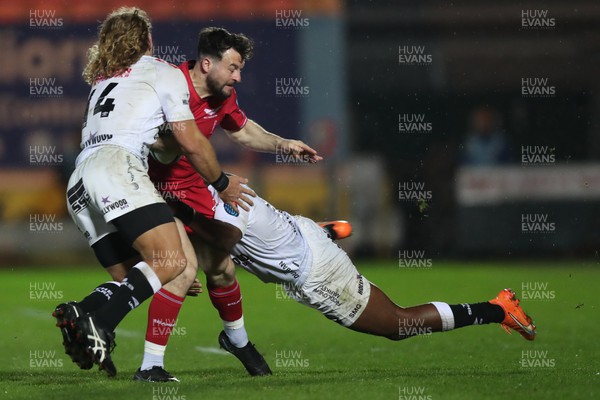 260424 - Scarlets v Hollywoodbets Sharks - United Rugby Championship - Ryan Conner of Scarlets is tackled by two Sharks players  