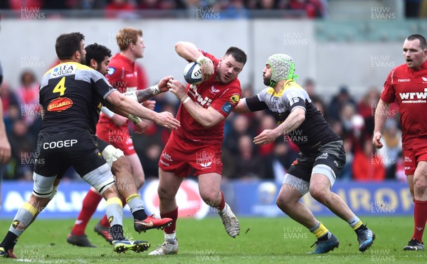300318 - Scarlets v La Rochelle - European Rugby Champions Cup - Rob Evans of Scarlets is tackled by Zeno Kieft and Kevin Gourdon of La Rochelle