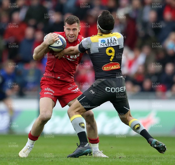 300318 - Scarlets v La Rochelle - European Champions Cup Quarter Final - Gareth Davies of Scarlets is tackled by Alexi Bales of La Rochelle