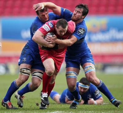 070315 - Scarlets v Leinster - Guinness PRO12 - Ken Owens of Scarlets is tackled by Kane Douglas and Rhys Ruddock of Leinster