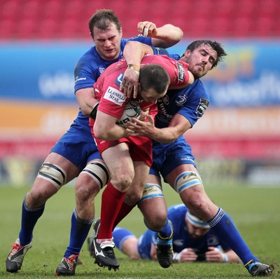 070315 - Scarlets v Leinster - Guinness PRO12 - Ken Owens of Scarlets is tackled by Kane Douglas and Rhys Ruddock of Leinster