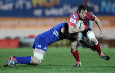 070315 - Scarlets v Leinster - Guinness PRO12 - Adam Warren of Scarlets is tackled by Tom Denton of Leinster