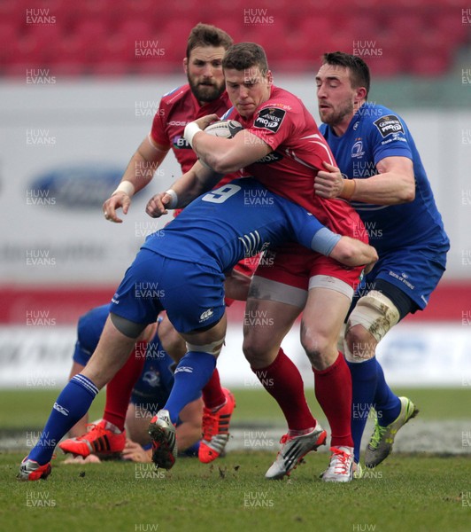 070315 - Scarlets v Leinster - Guinness PRO12 - Scott Williams of Scarlets is tackled by Eoin Reddan and Jack Conan of Leinster