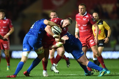 080918 - Scarlets v Leinster - Guinness PRO14 - Rob Evans of Scarlets is tackled by Ian Nagle and Tadhg Furlong of Leinster