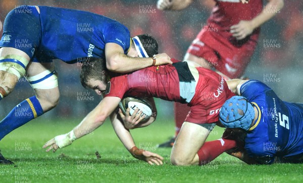 090318 - Scarlets v Leinster - Guinness PRO14 - Jonathan Evans of Scarlets is tackled by Josh Murphy and Scott Fardy of Leinster