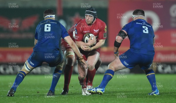 090318 - Scarlets v Leinster - Guinness PRO14 - Ryan Elias of Scarlets is tackled by Josh Murphy and Michael Bent of Leinster