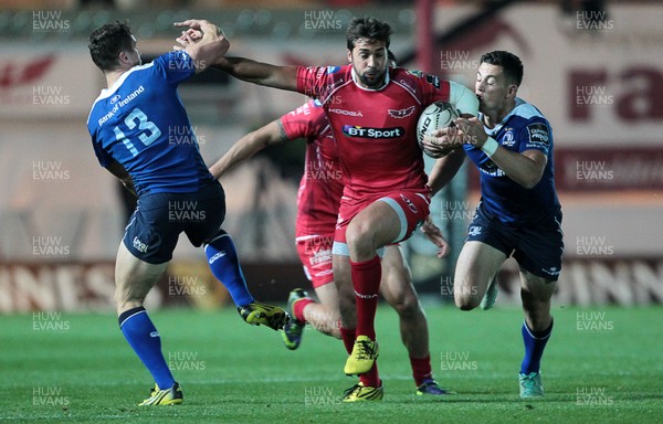 161015 - Scarlets v Leinster - Guinness PRO12 - Gareth Owen of Scarlets is tackled by Colm O'Shea and Noel Reid of Leinster