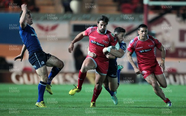 161015 - Scarlets v Leinster - Guinness PRO12 - Gareth Owen of Scarlets is tackled by Colm O'Shea and Noel Reid of Leinster