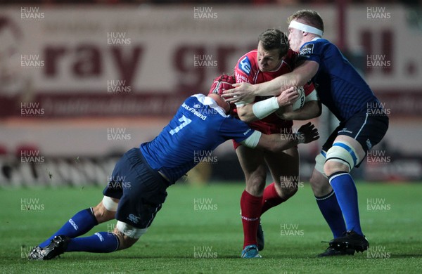 161015 - Scarlets v Leinster - Guinness PRO12 - Hadleigh Parkes of Scarlets is tackled by Josh van der Flier and Marty Moore of Leinster