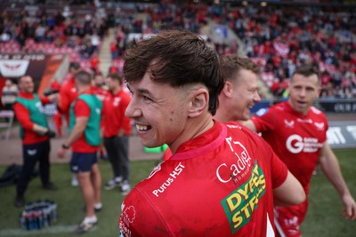 260425 - Scarlets v Leinster - United Rugby Championship - Tom Rogers of Scarlets and Head Coach Dwyane Peel celebrate the victory at full time