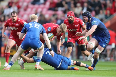 260425 - Scarlets v Leinster - United Rugby Championship - Taine Plumtree  of Scarlets is stopped by Will Connors of Leinster