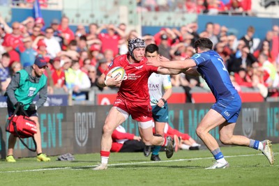 260425 - Scarlets v Leinster - United Rugby Championship - Tom Rogers of Scarlets fends off Jimmy O’Brien of Leinster 