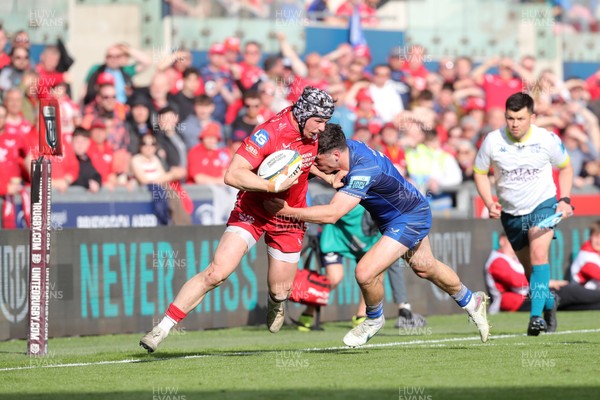 260425 - Scarlets v Leinster - United Rugby Championship - Tom Rogers of Scarlets fends off Jimmy O’Brien of Leinster 