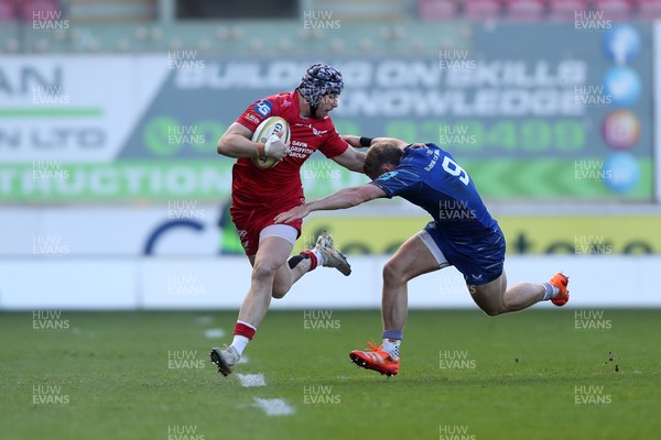 260425 - Scarlets v Leinster - United Rugby Championship - Tom Rogers of Scarlets hands off Fintan Gunne of Leinster 