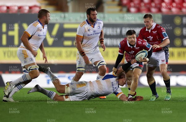 281022 - Scarlets v Leinster - BKT United Rugby Championship - Steff Evans of Scarlets is tackled by Max Deegan of Leinster