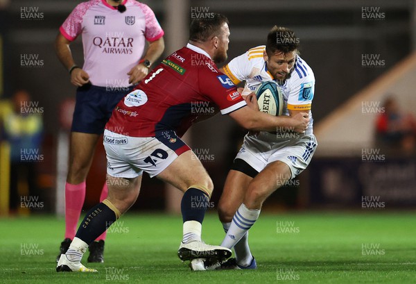 281022 - Scarlets v Leinster - BKT United Rugby Championship - Ross Byrne of Leinster is tackled by Steff Thomas of Scarlets