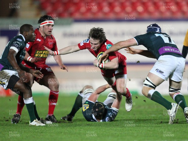 28.01.12 - Scarlets v London Irish, LV= Cup -  Scarlets Rhodri Williams  is tackled by London Irish's Keiran Low and David Sisi  